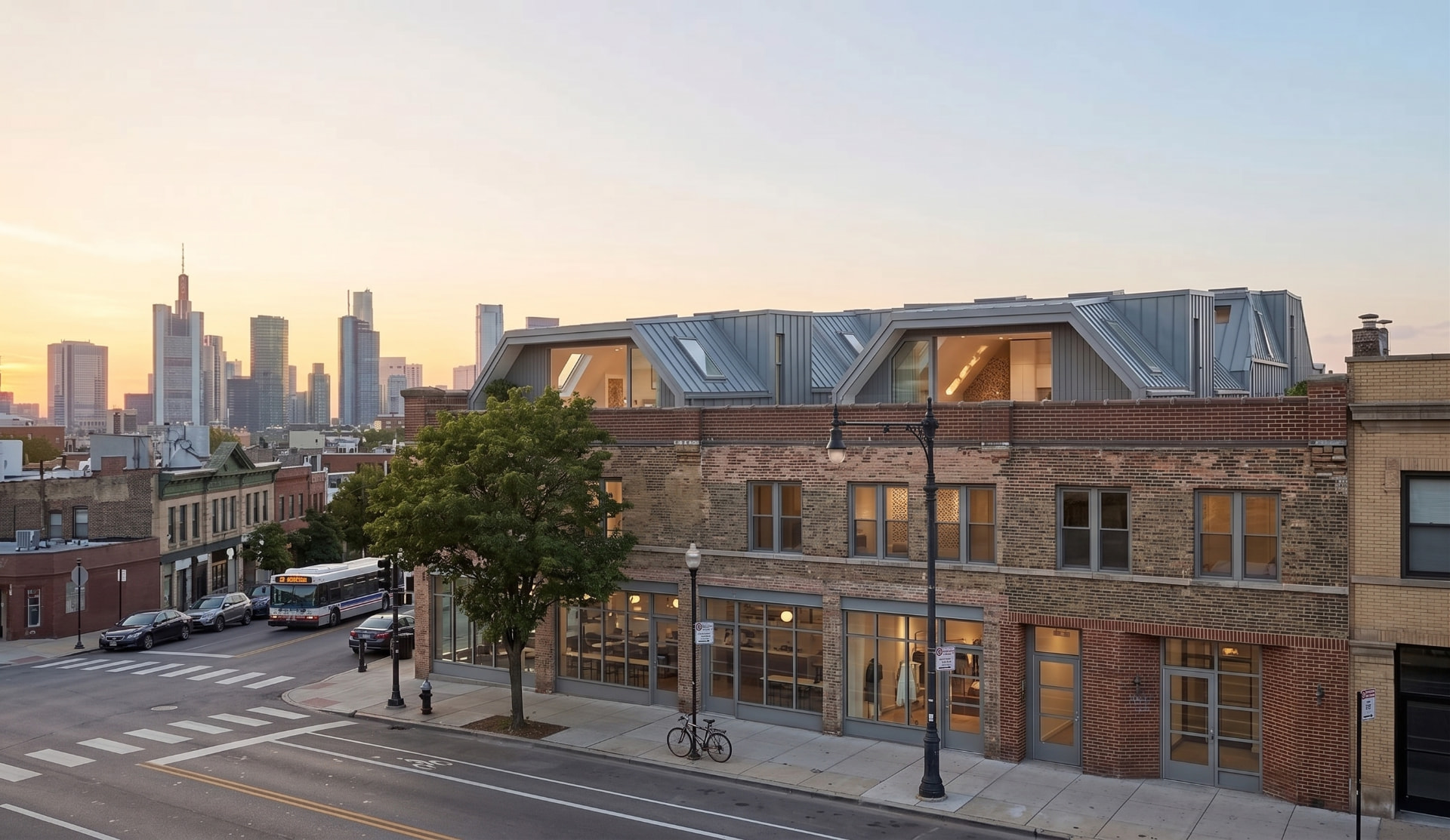 Aerial view of contemporary rooftop homes installed on a heritage brick building with a downtown skyline at sunset